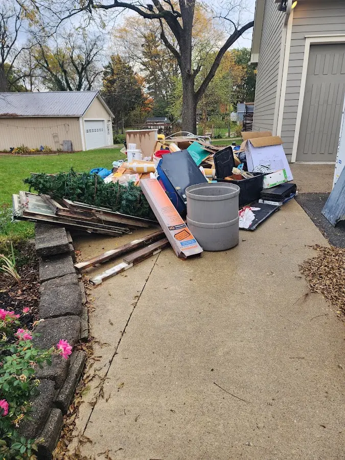 Dumpster being loaded with debris for Demolition Dumpster Rental in Sidney